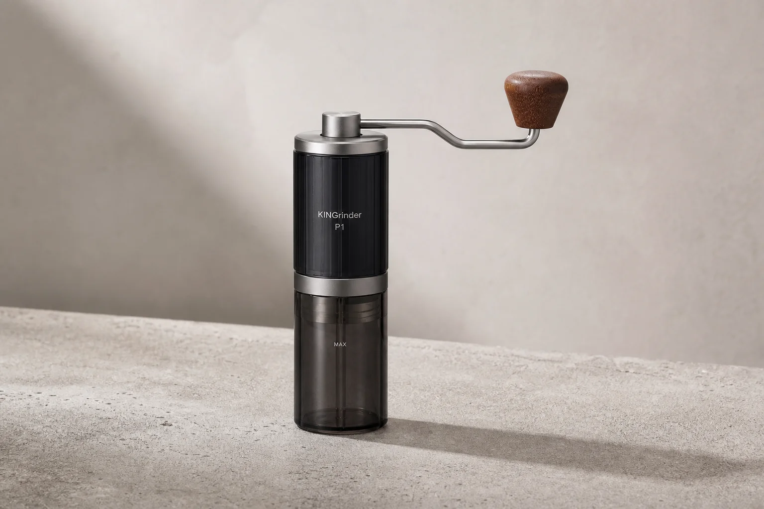KINGrinder P1 hand grinder on concrete surface with metal handle and wooden accent