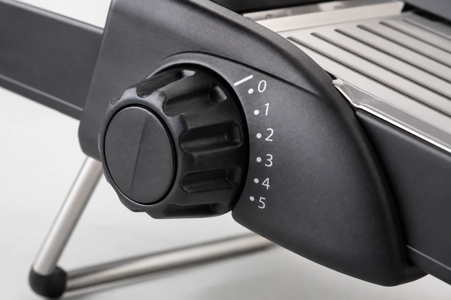 Adjustment dial on a mandoline slicer showing thickness settings