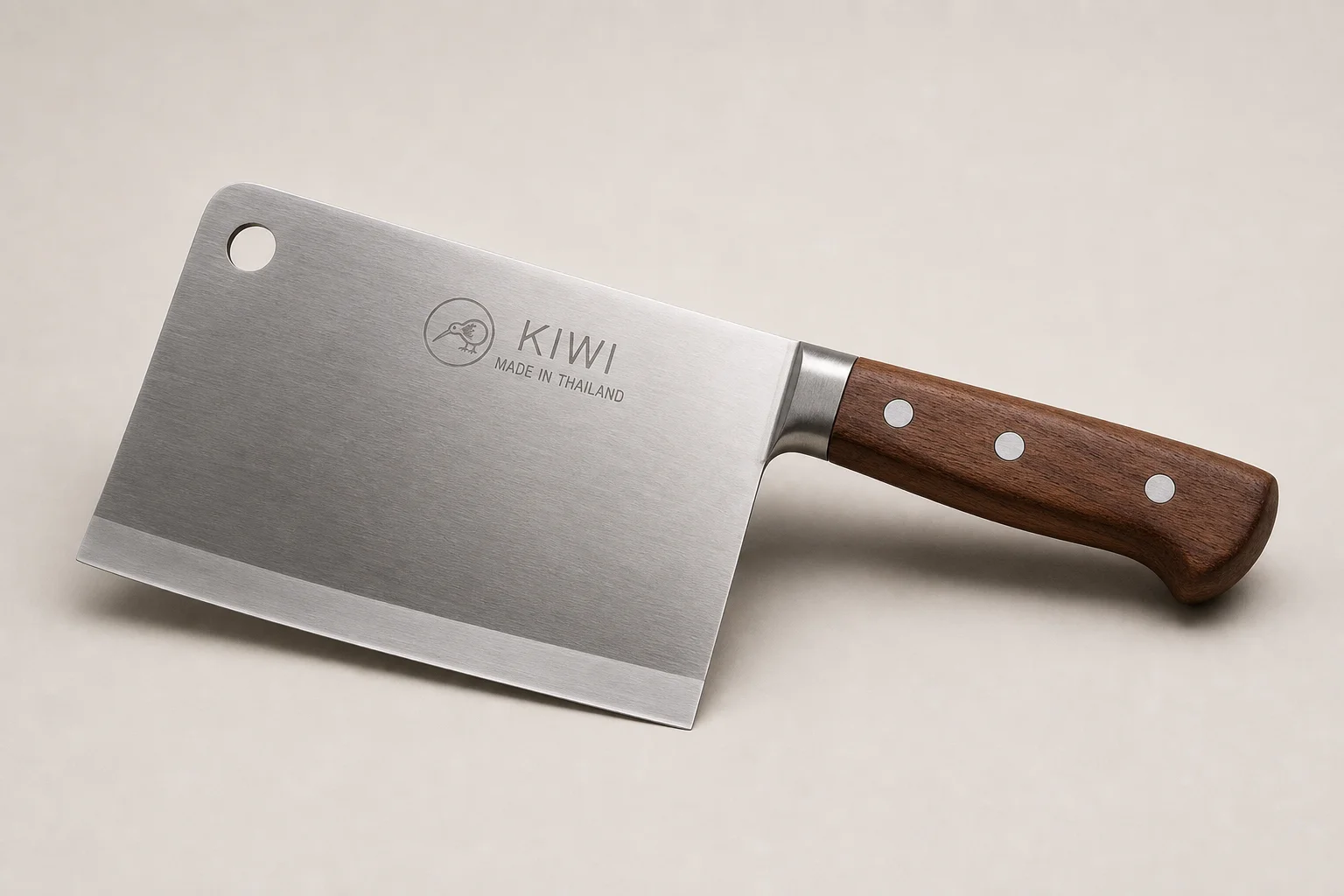 Professional kitchen knives and tools arranged on concrete surface