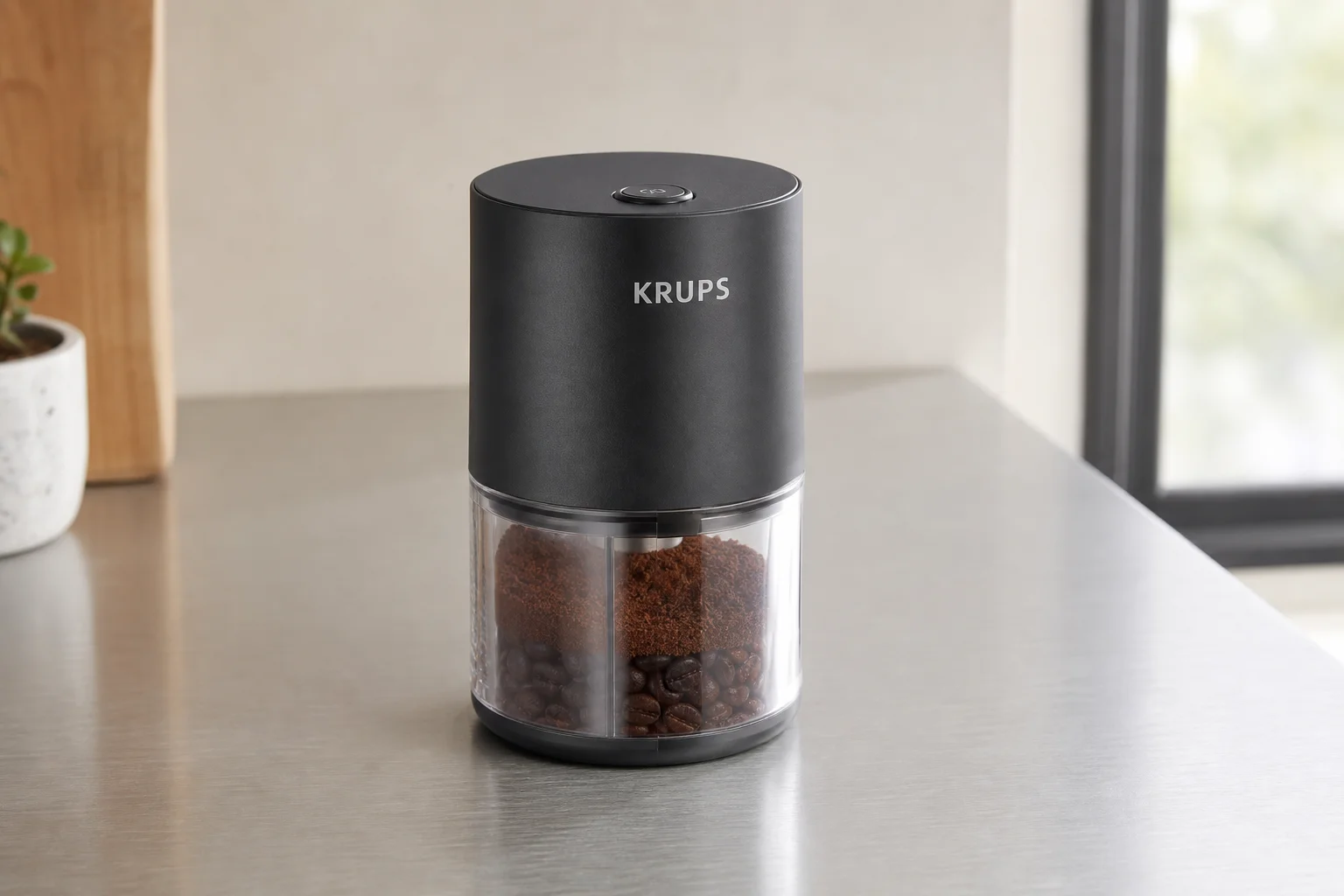 Five coffee grinders arranged by size on a concrete surface