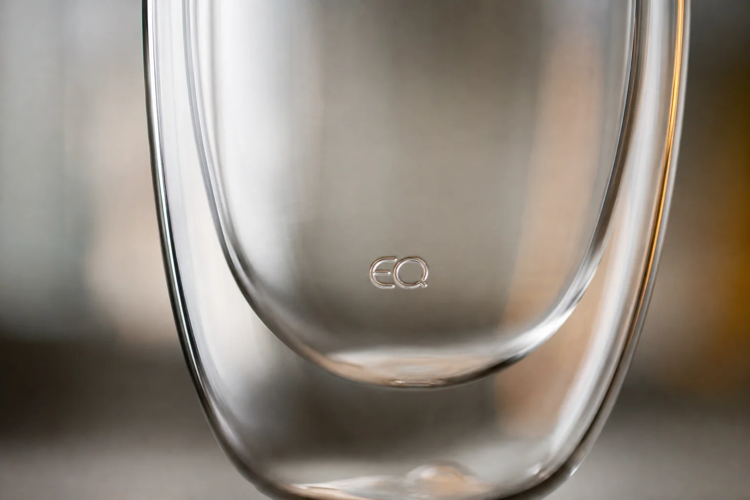Close-up of EQ logo printed inside the glass double-wall