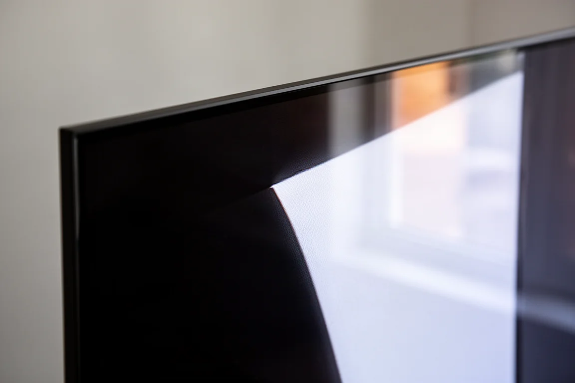 Macro view of a television screen showing deep black meeting a bright highlight