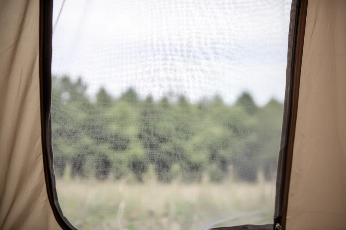 View from inside a one-person tent looking through a fine mesh door panel