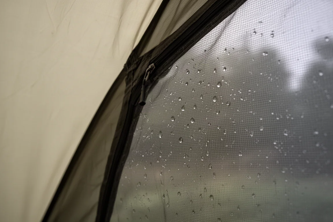 Tent fly panel resting close to the mesh inner wall with condensation droplets