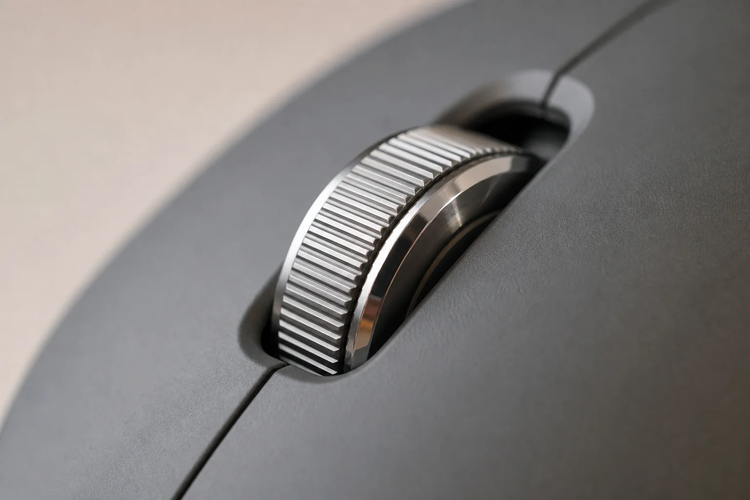 Detaljbild av scrollhjulet i stål på en ergonomisk mus med taktila räfflor