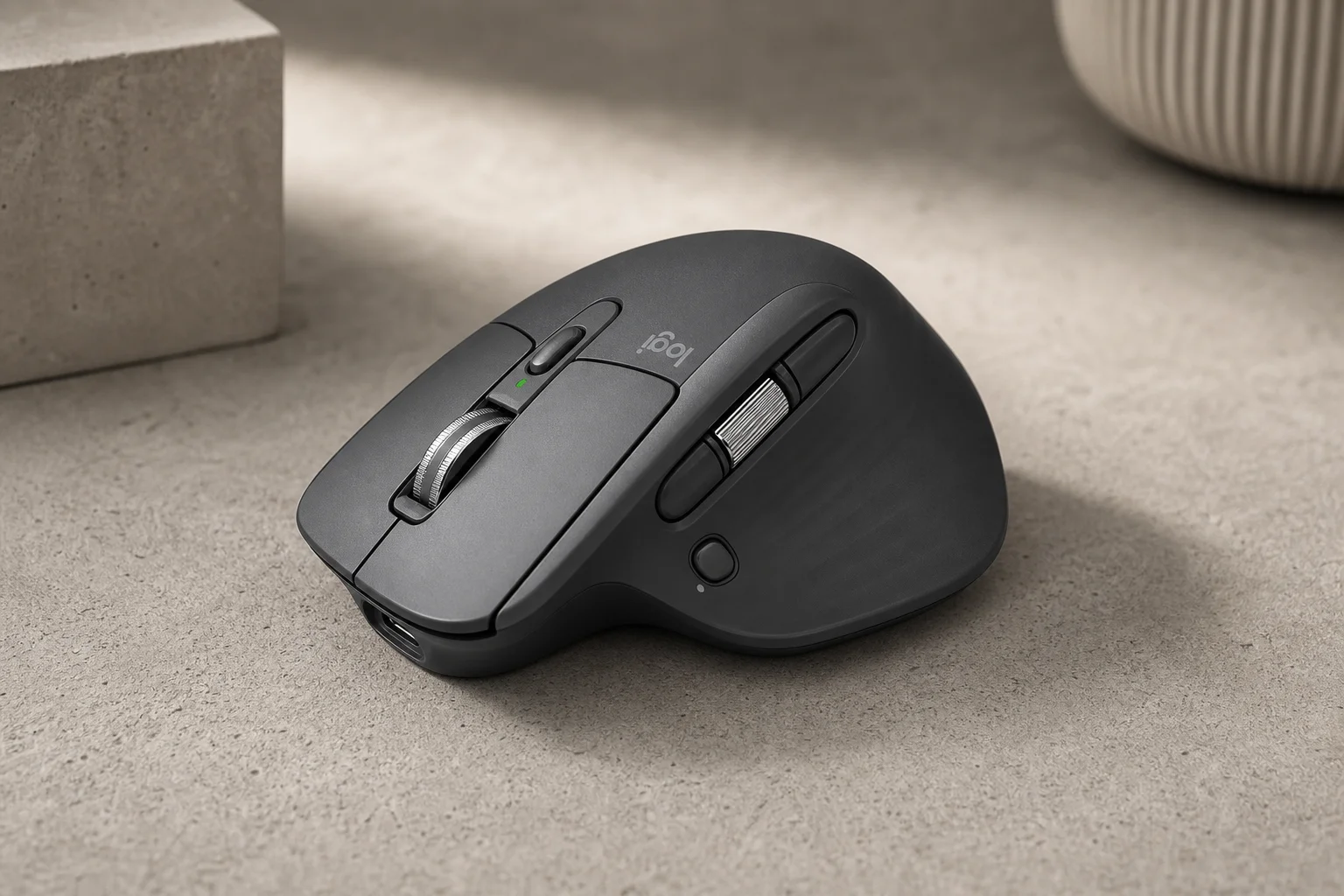 Logitech MX Master 4 wireless mouse in graphite grey on concrete surface