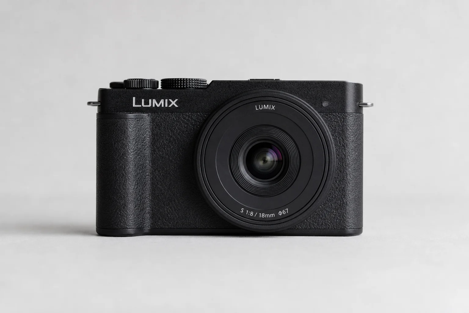Four full-frame mirrorless cameras arranged on concrete surface
