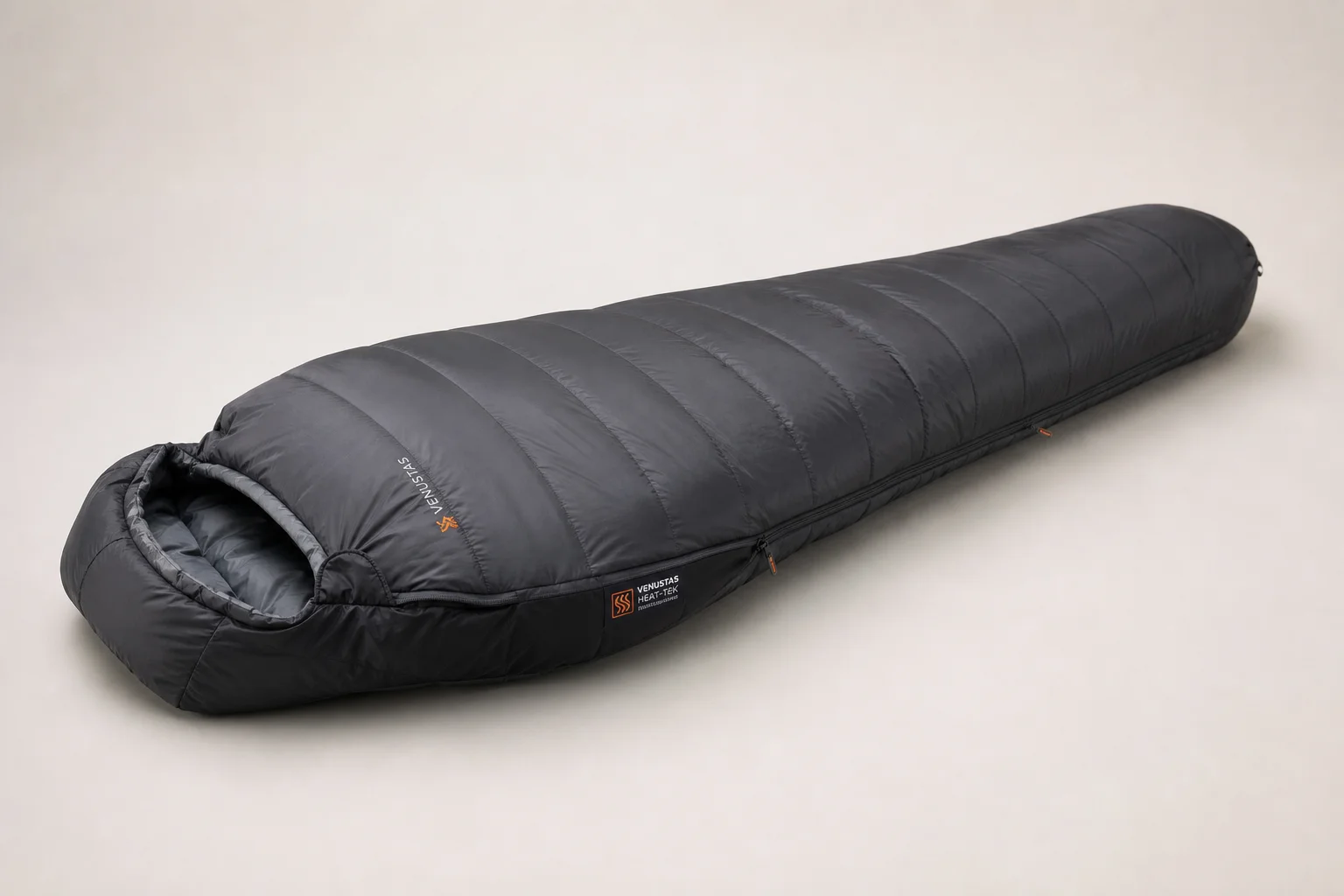 Five heated sleeping bags in various styles arranged on concrete surface