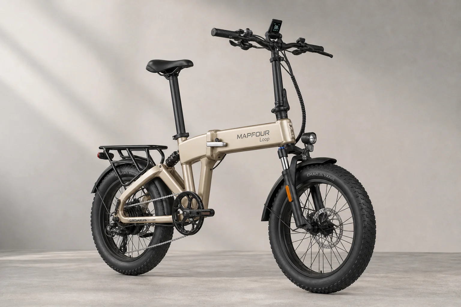 MapFour Loop champagne gold folding ebike with 20-inch tires and integrated battery on grey surface