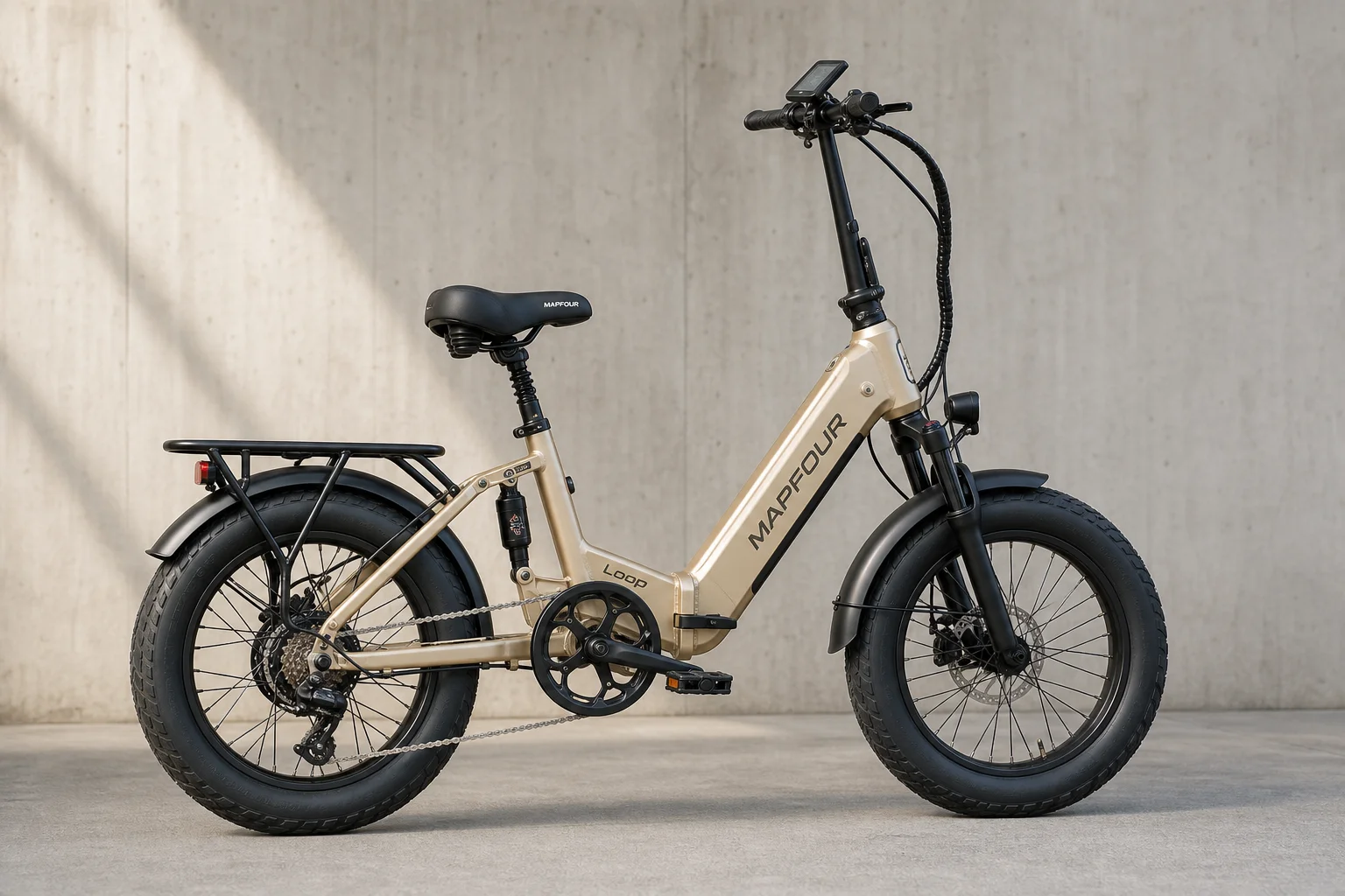 MapFour Loop champagne gold folding ebike with 20-inch tires and integrated battery on grey surface