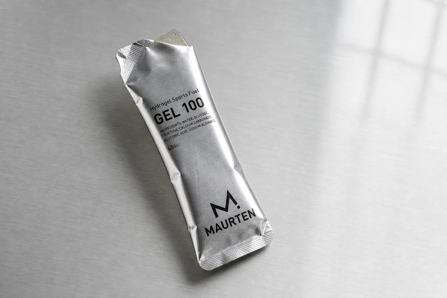 High5 Energy Gel and Maurten Gel 100 sachets side by side on concrete