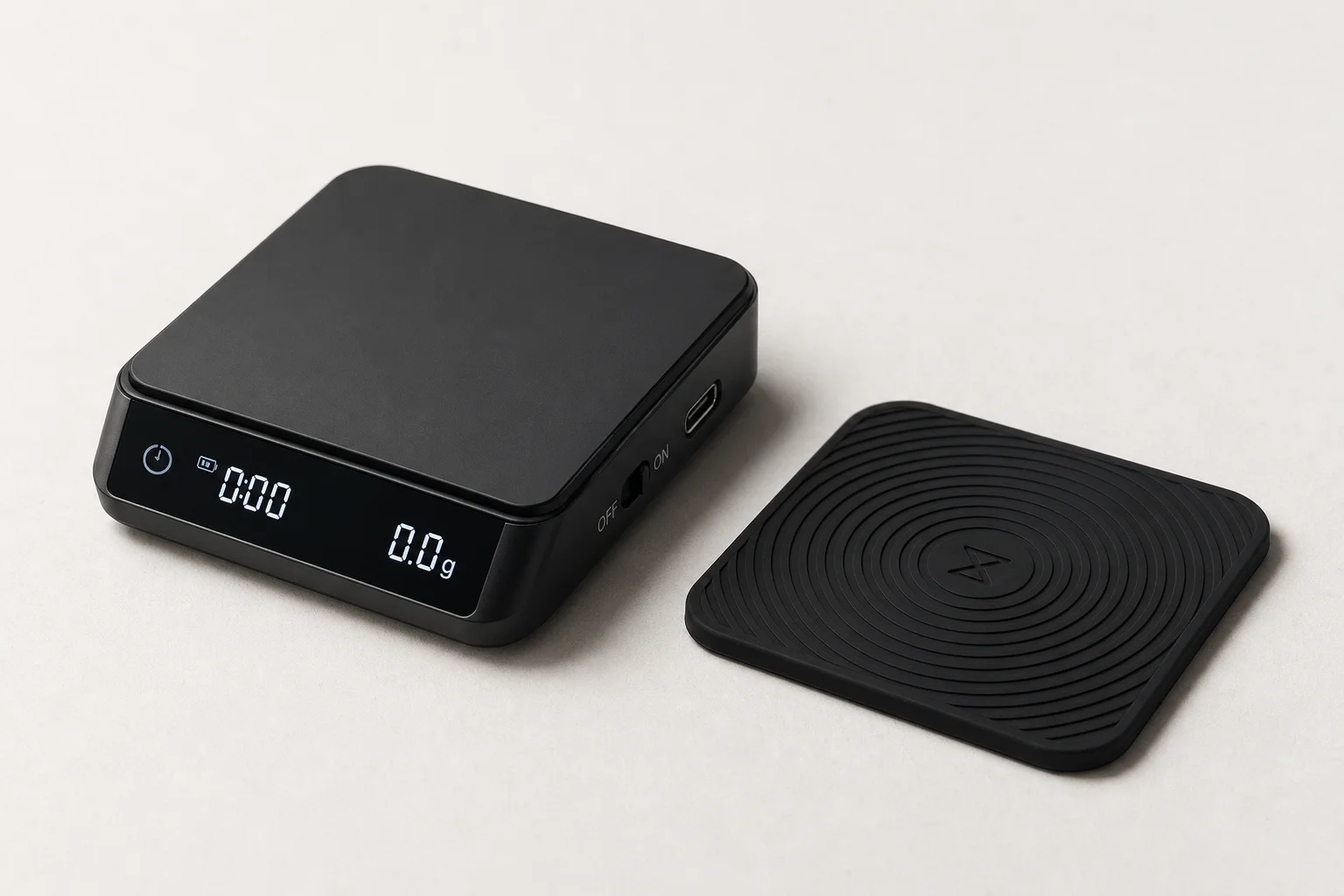 Three compact coffee scales arranged on concrete: MHW-3Bomber Micro, Cube Pro Max, and Timemore Black Mirror Nano