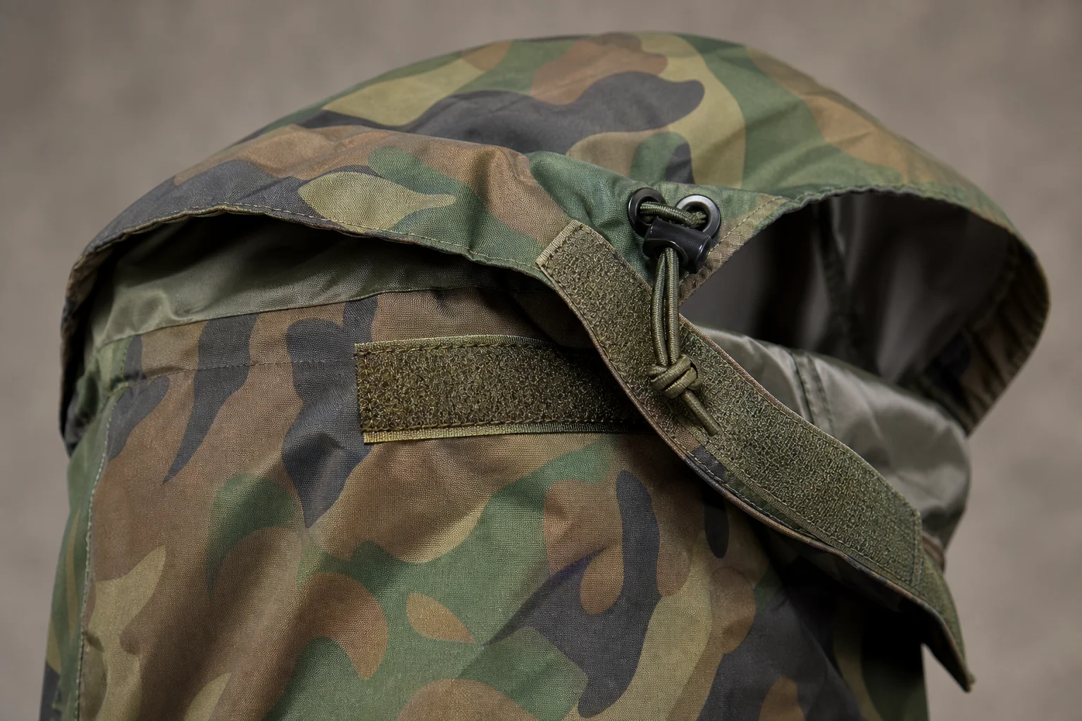 Close-up detail of bivvy hood closure with hook-and-loop fasteners and drawstring