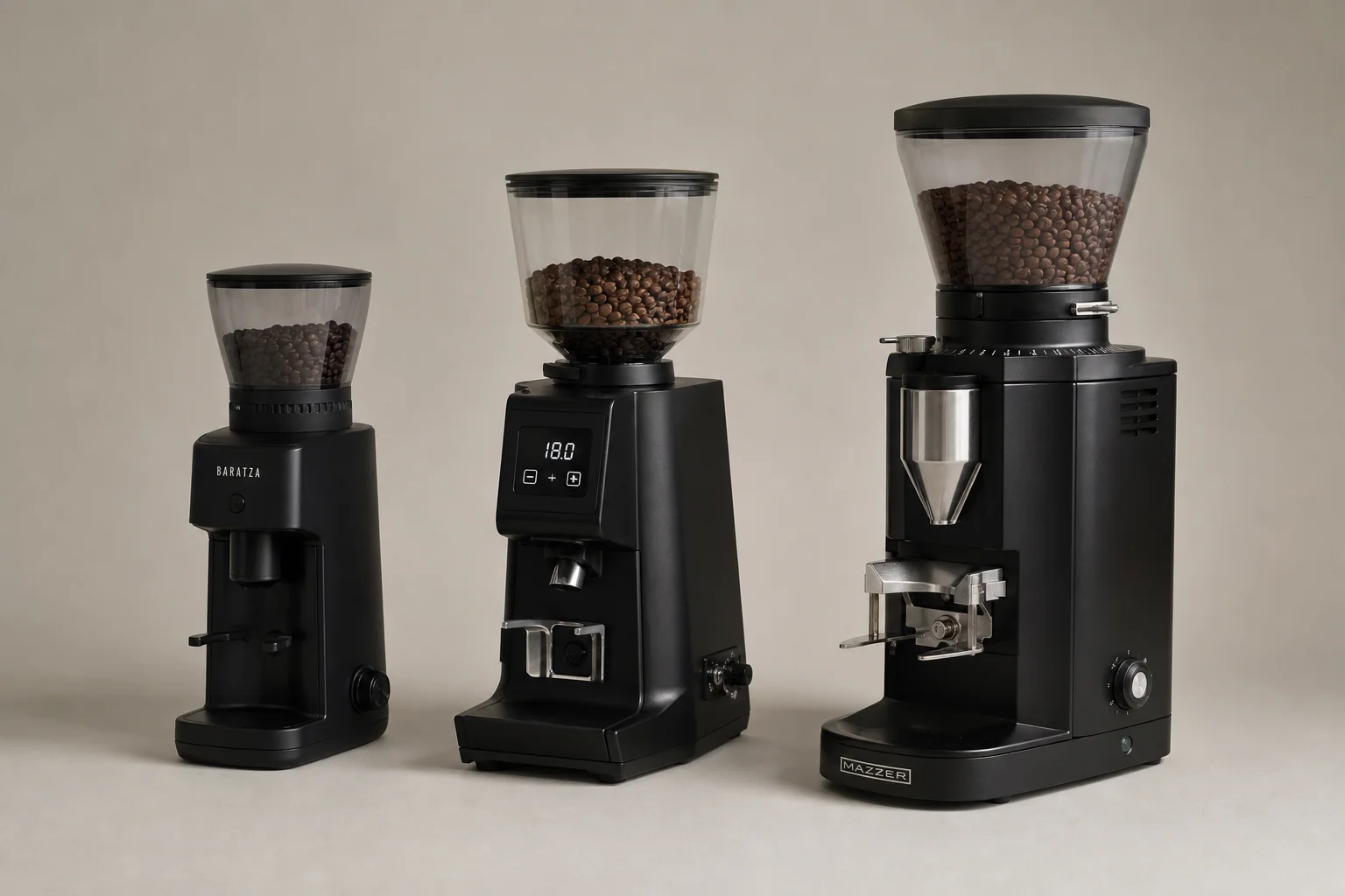 Three espresso grinders arranged side by side for comparison