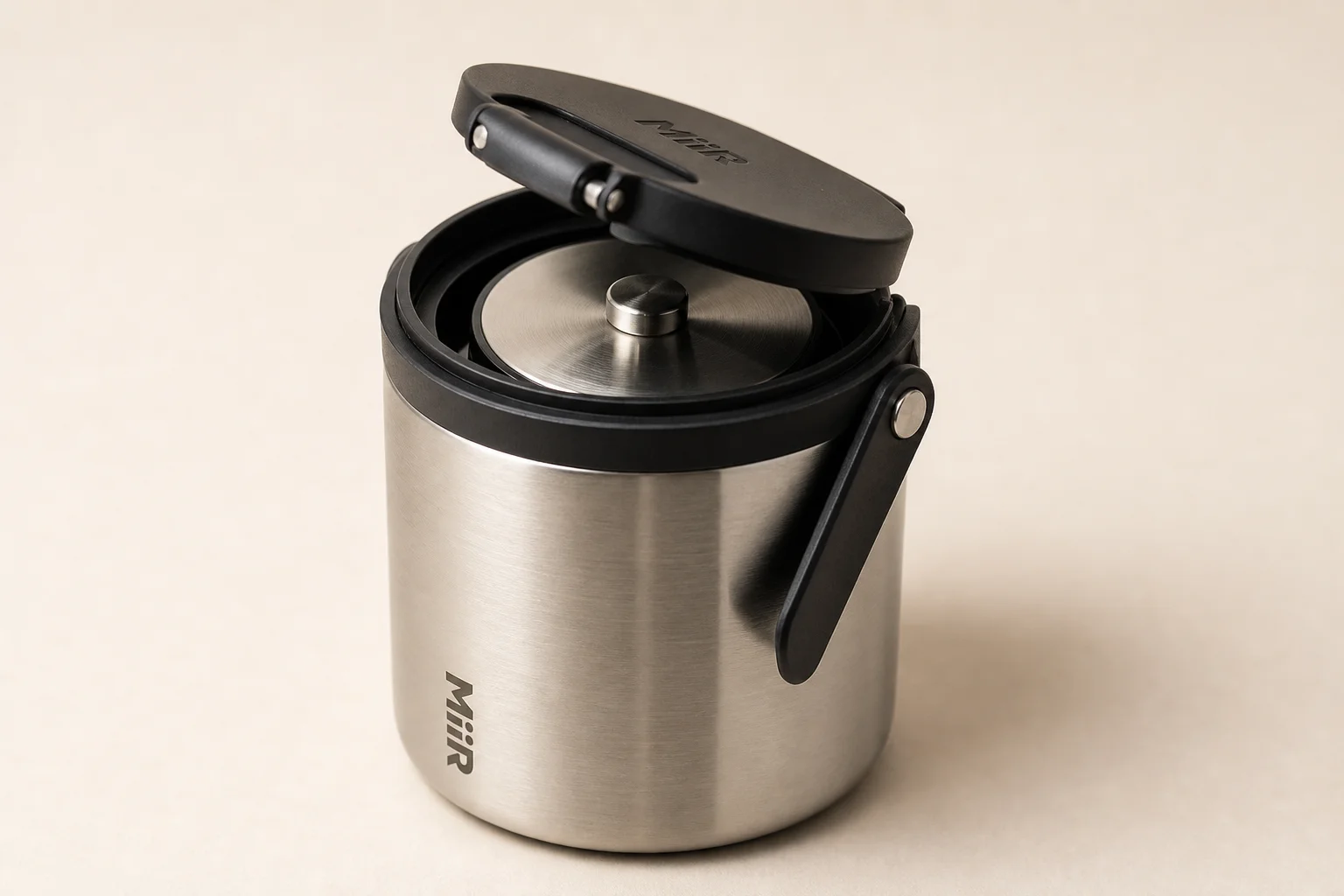 Eleven coffee storage containers arranged by category on concrete surface