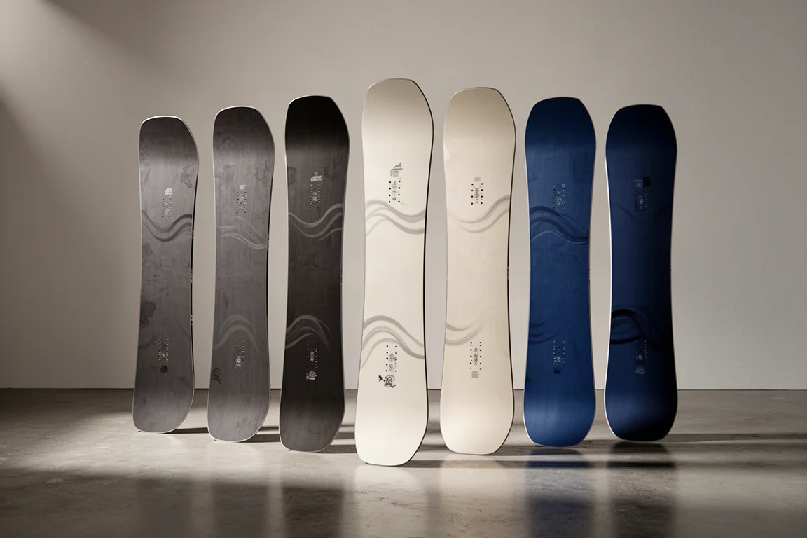 Row of freeride snowboards standing upright on a polished concrete floor