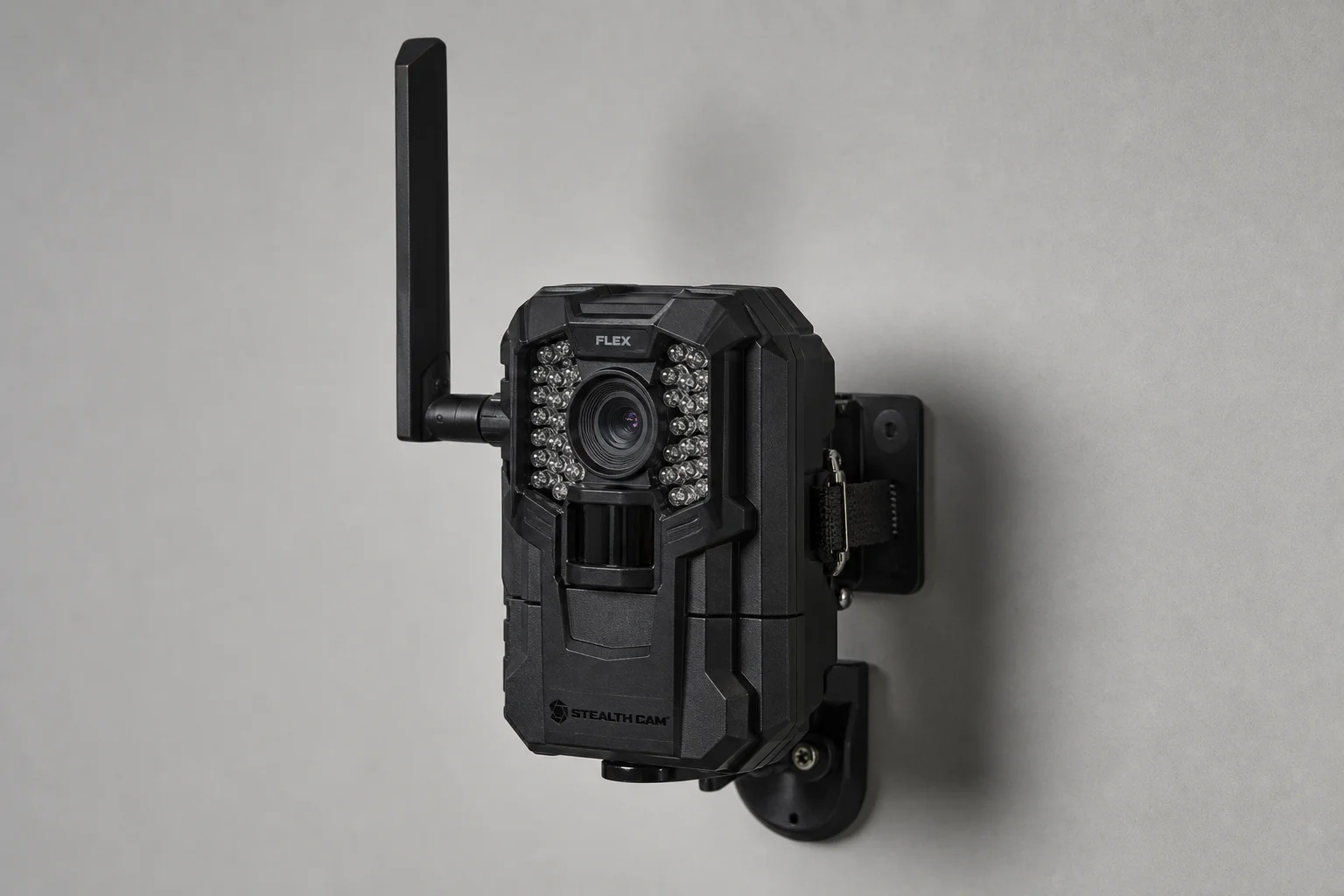 Five trail cameras displayed on weathered wood surface