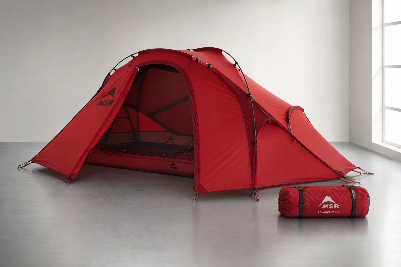 Five ultralight tents displayed on concrete surface showing variety of designs and colors