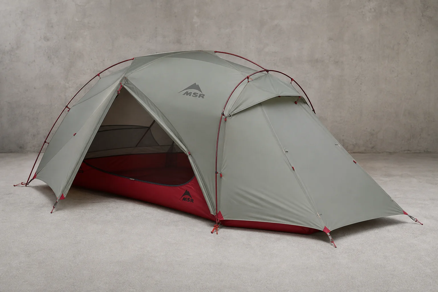 Nine hiking tents arranged on neutral backdrop showing variety in size and design