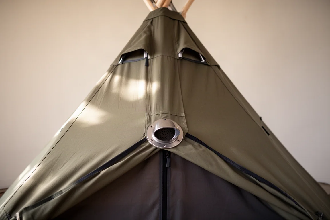 Interior of a pyramid tipi tent showing a stove jack port and apex vents