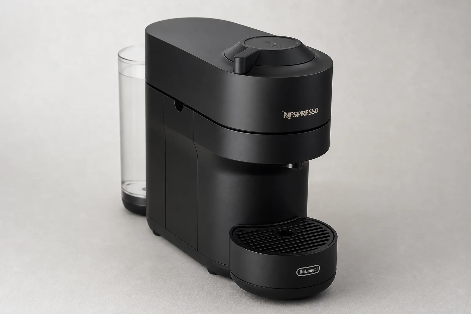 Nespresso Vertuo POP+ compact coffee machine on neutral grey background