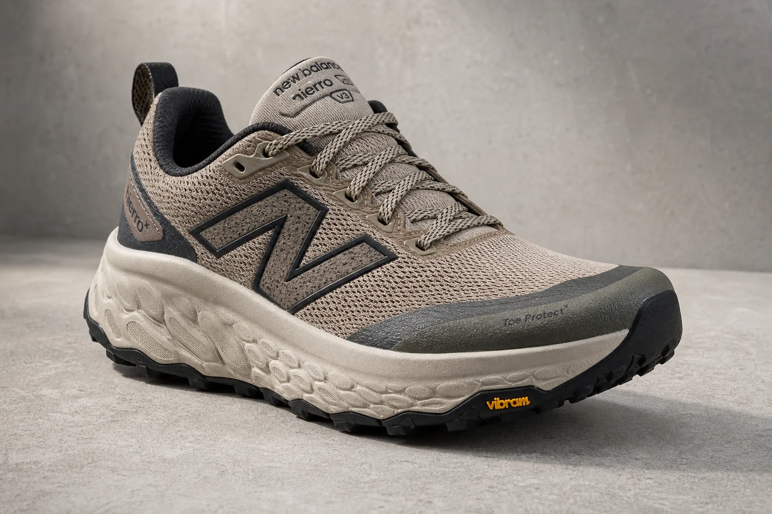 Seven trail running and hiking shoes arranged on concrete surface
