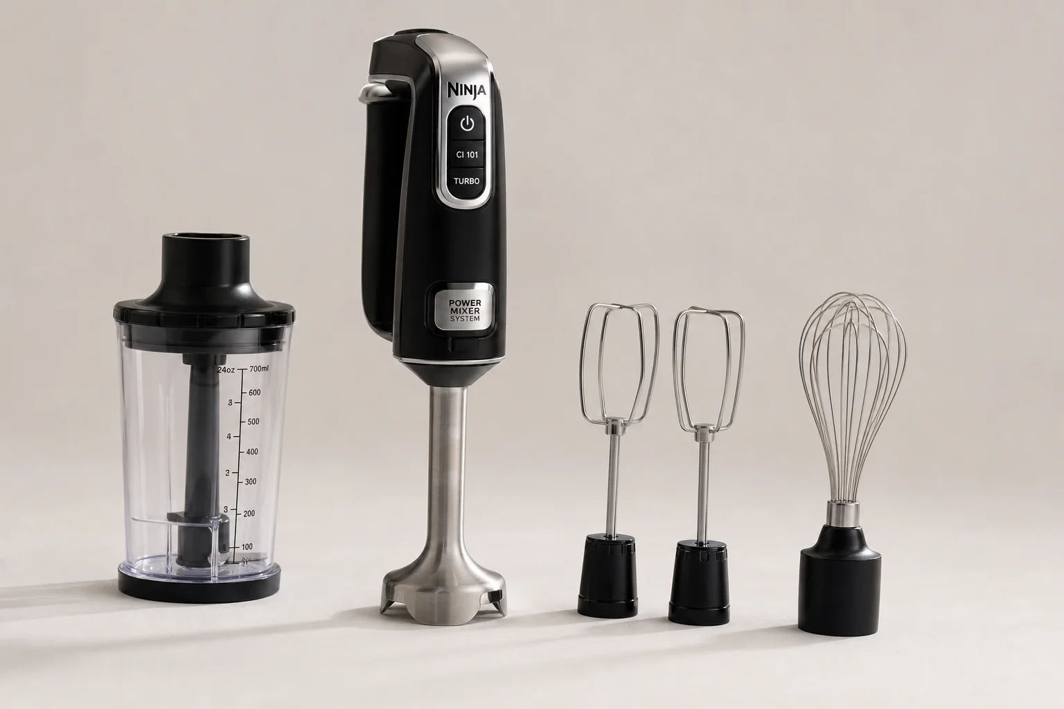Five immersion blenders arranged by size on concrete surface