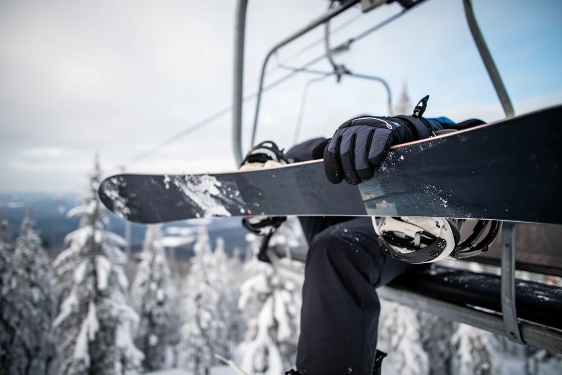 Snowboard carving a tight arc on firm piste leaving a defined edge line