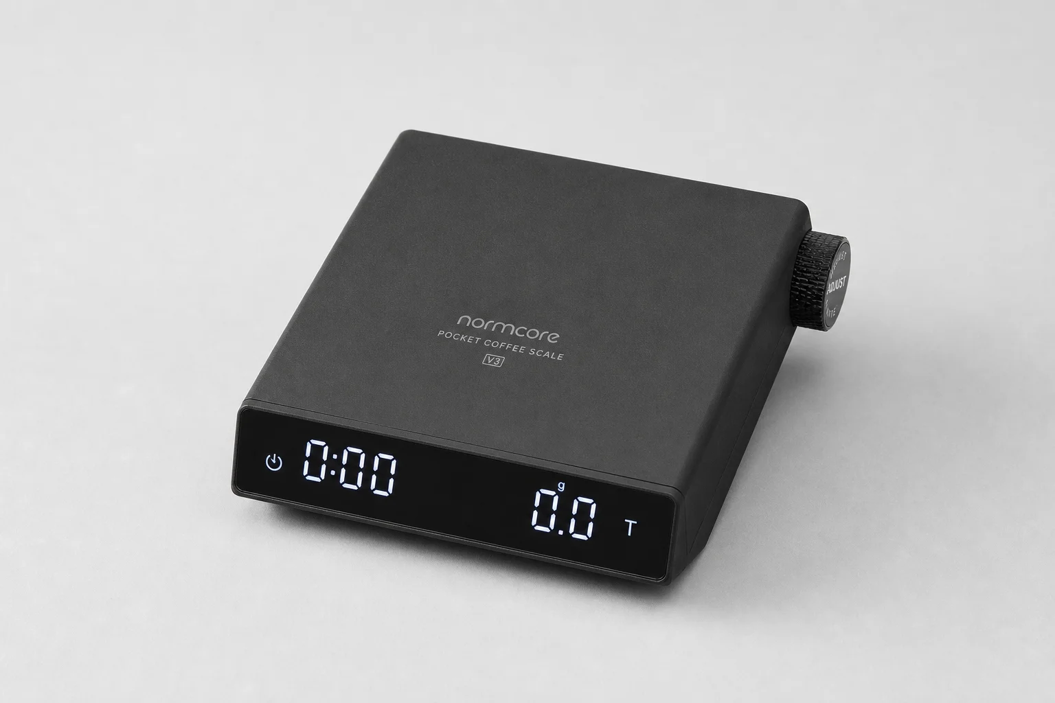 Normcore Pocket Coffee Scale V3 on grey backdrop showing compact aluminum design and digital display