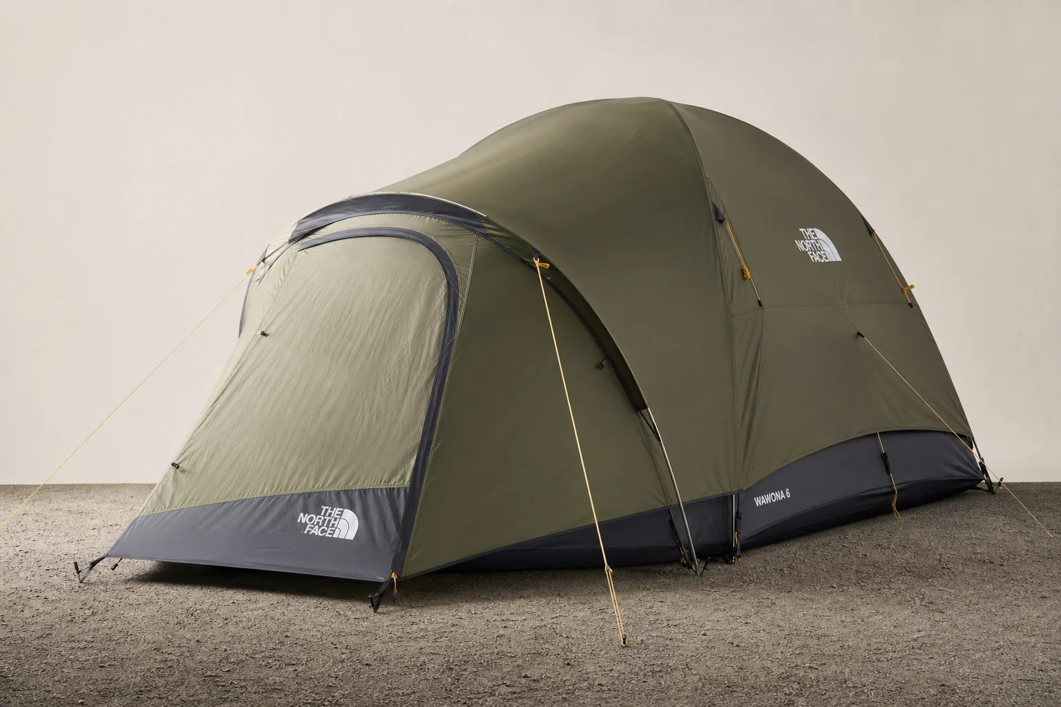 Six camping tents of varying sizes and styles arranged on a grey surface