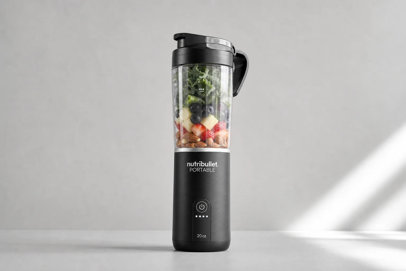 Five cordless blenders arranged on grey concrete surface