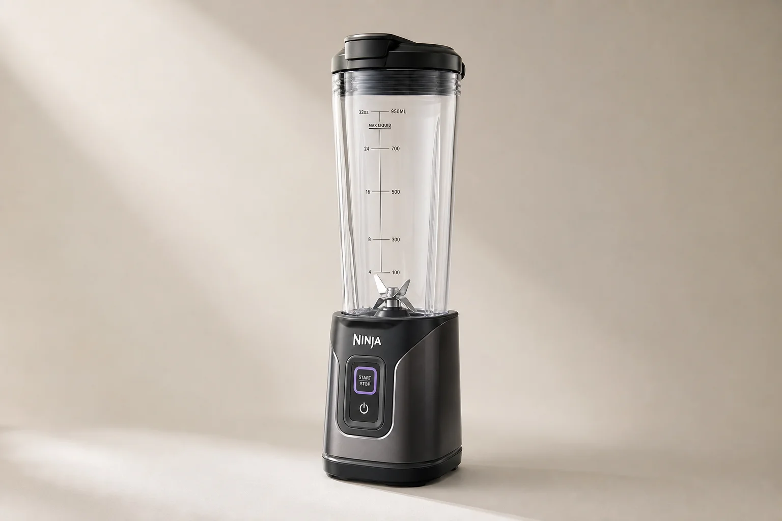 Five kitchen blenders arranged on concrete surface from compact to premium models
