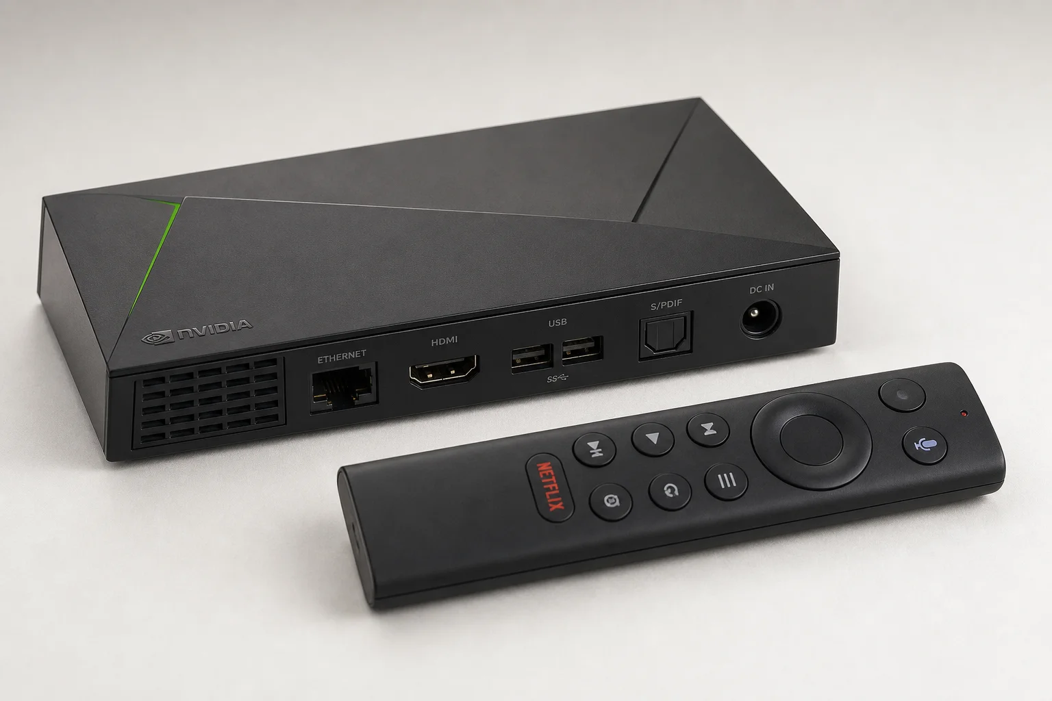 Collection of black Android TV boxes on neutral grey surface showing various form factors