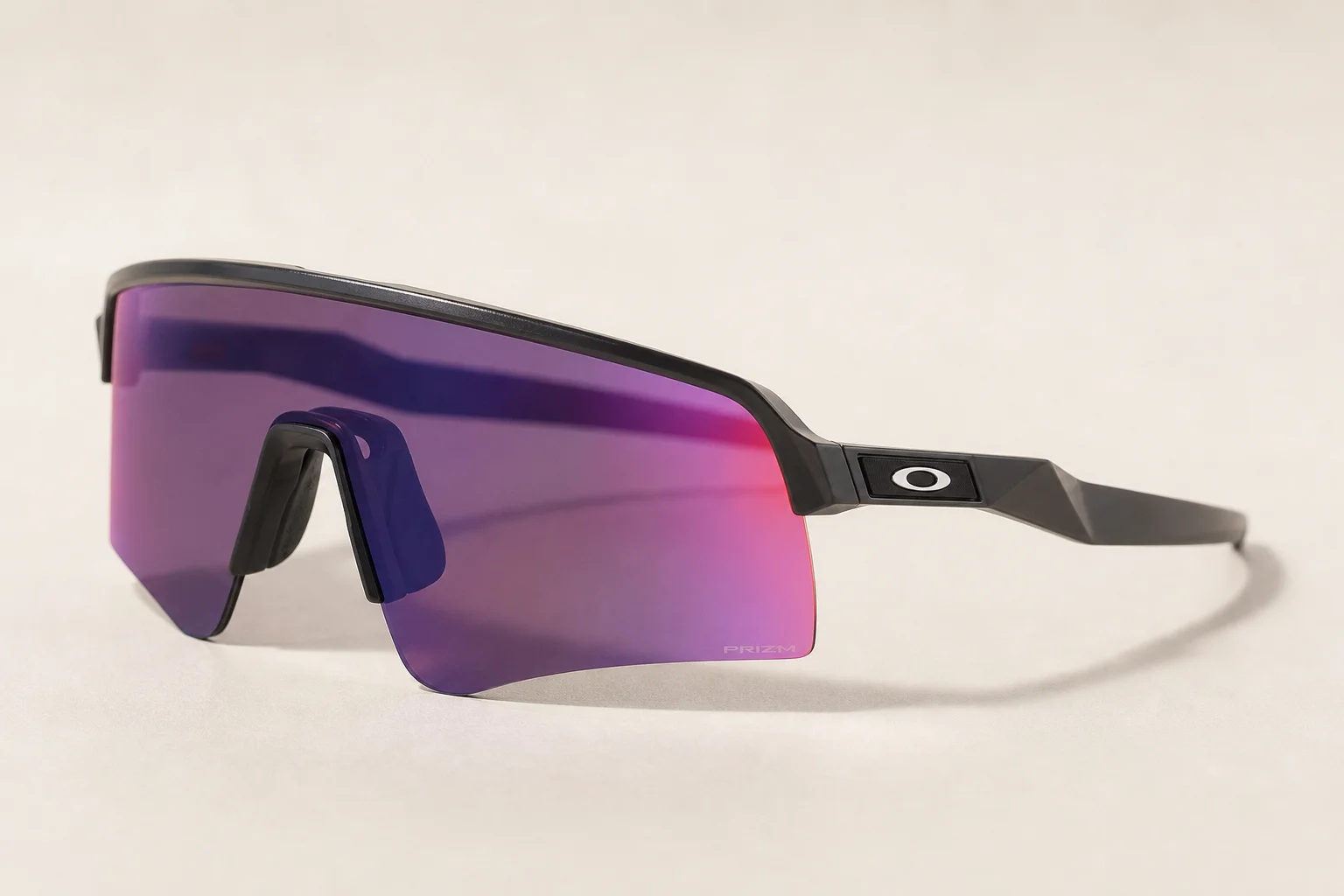 Seven Oakley shield sunglasses arranged on neutral backdrop showing different frame styles