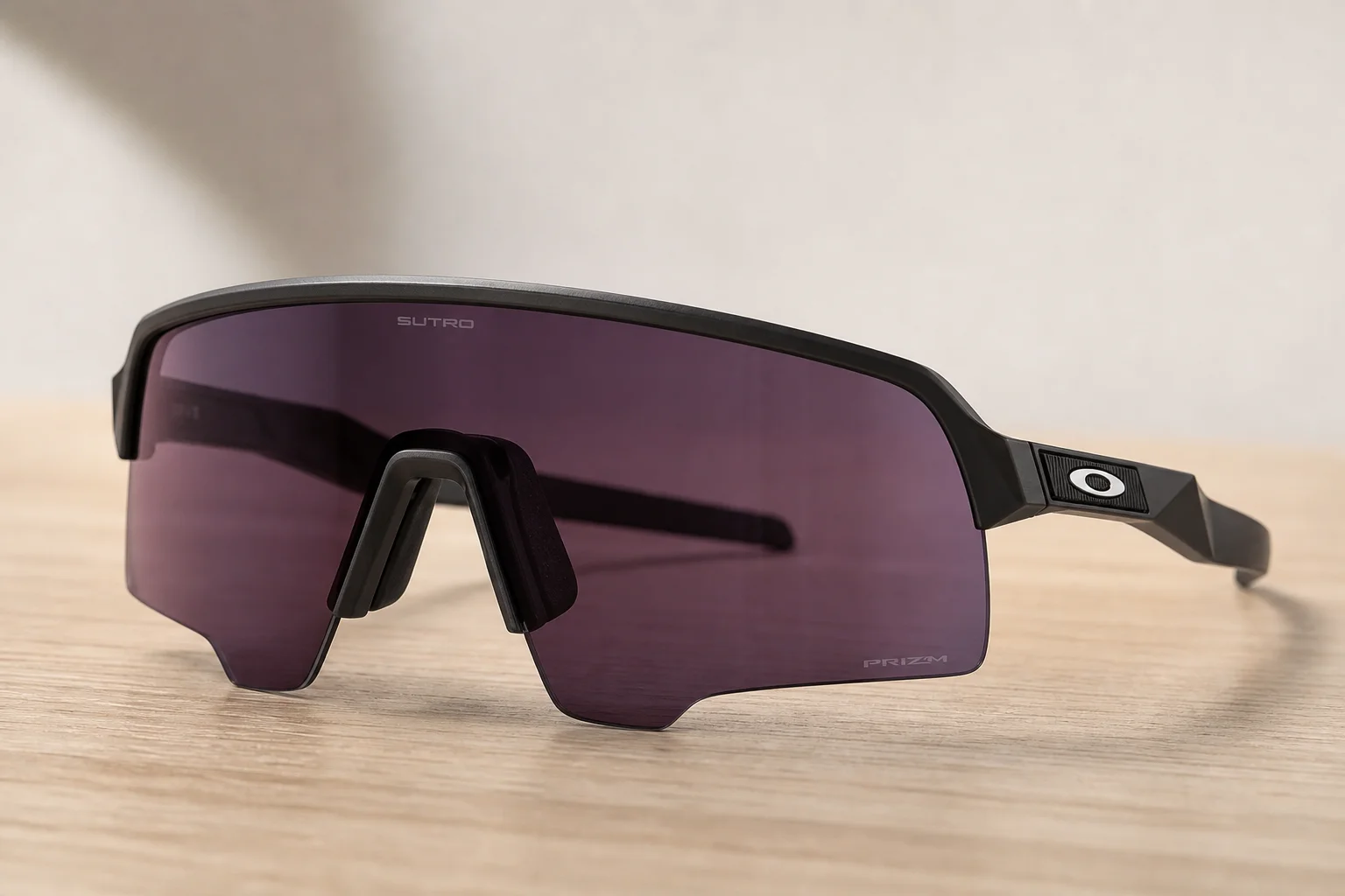 Seven Oakley shield sunglasses arranged on neutral backdrop showing different frame styles