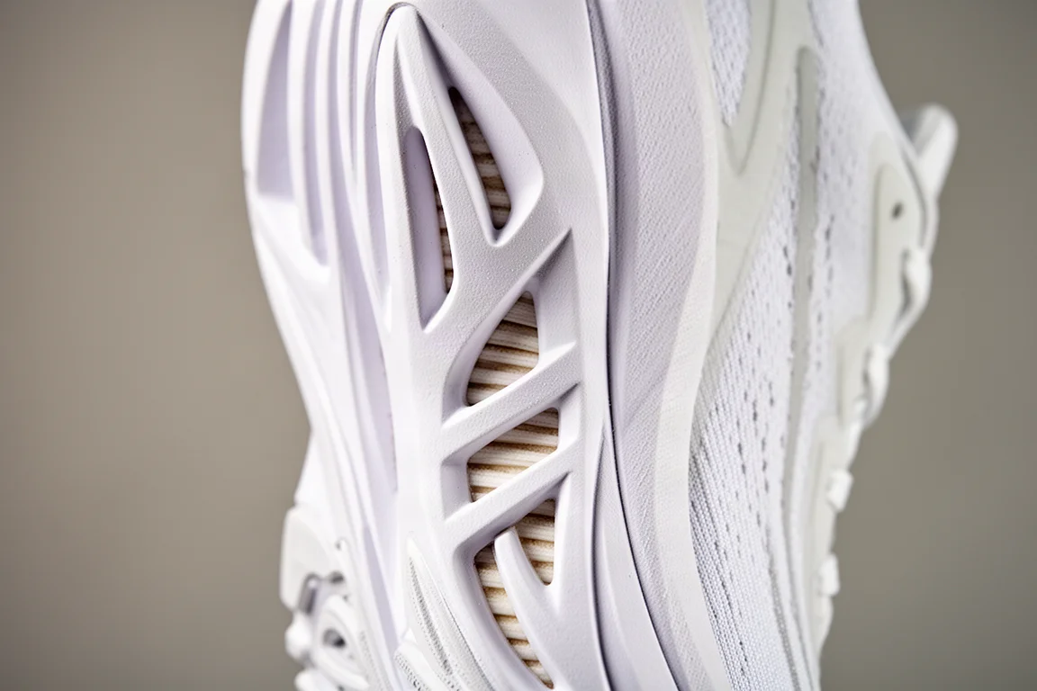 Close-up of a sculpted running shoe midsole showing side cutout channels