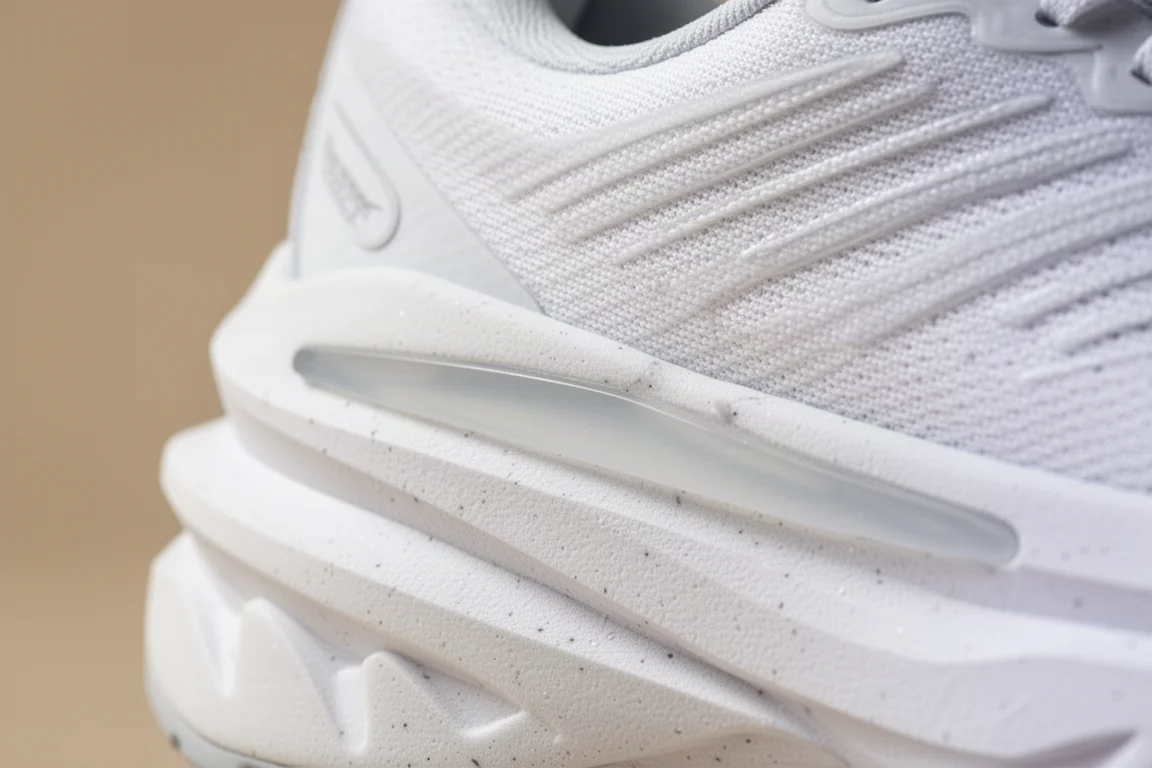 Close-up of a thick white foam midsole with a plate visible mid-layer