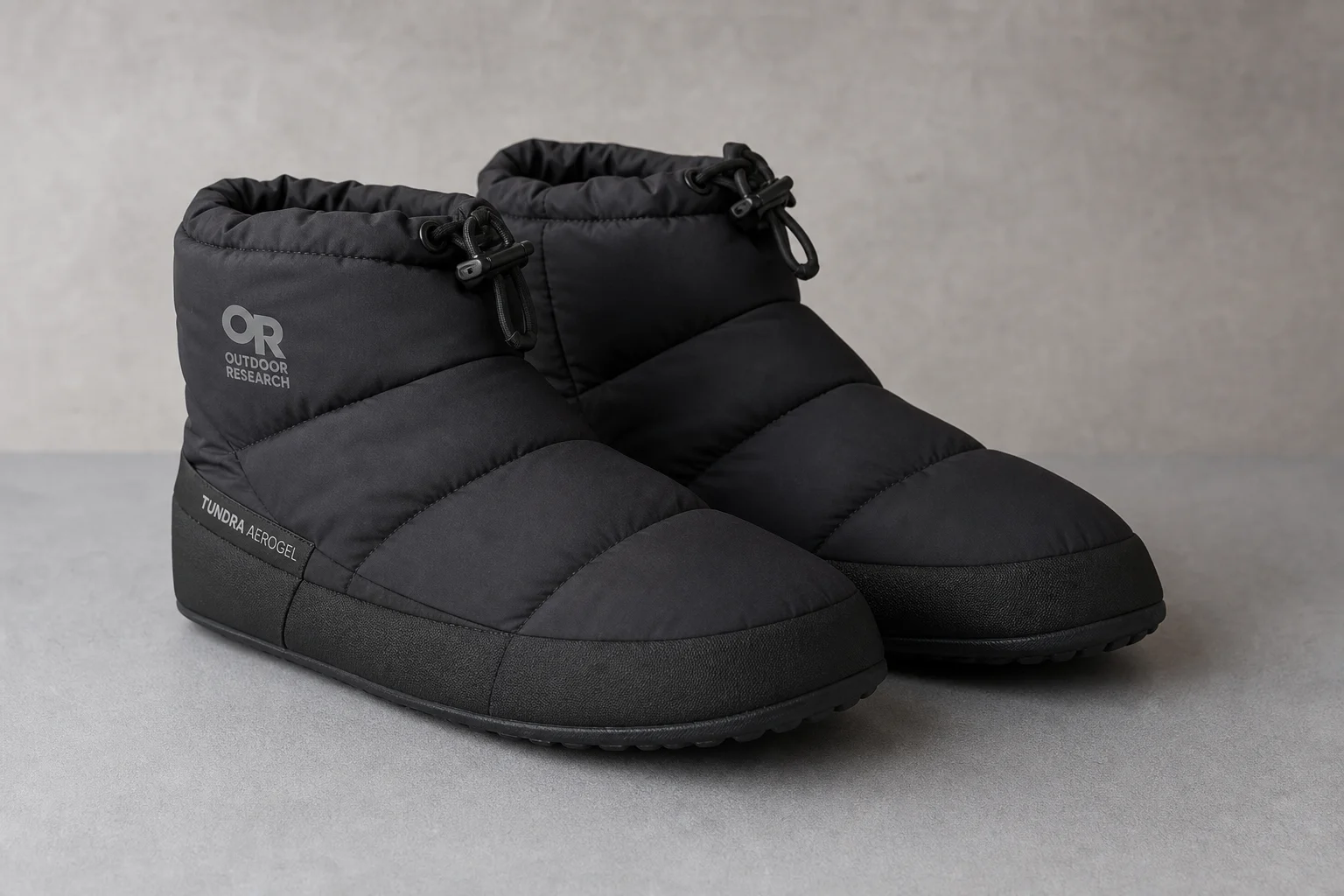 Winter hiking boot setup with pac boots, socks, gaiters, and booties on snow