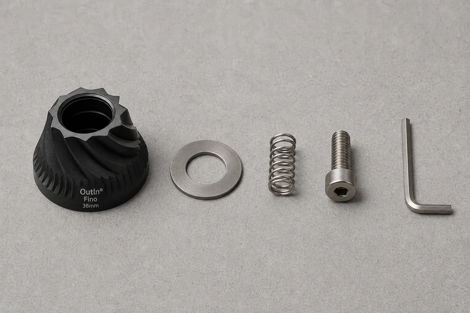 Disassembled burr chamber showing the 38mm conical burr and internal components laid out