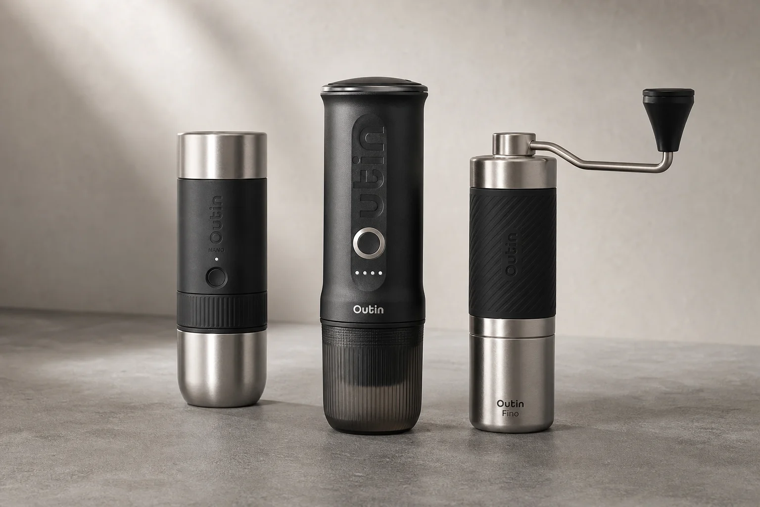 Outin Mino, Nano, and Fino portable espresso maker and grinder on concrete