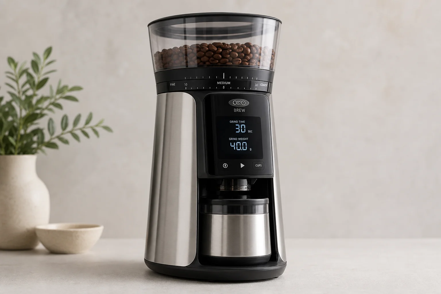 Five coffee grinders arranged by size on a concrete surface
