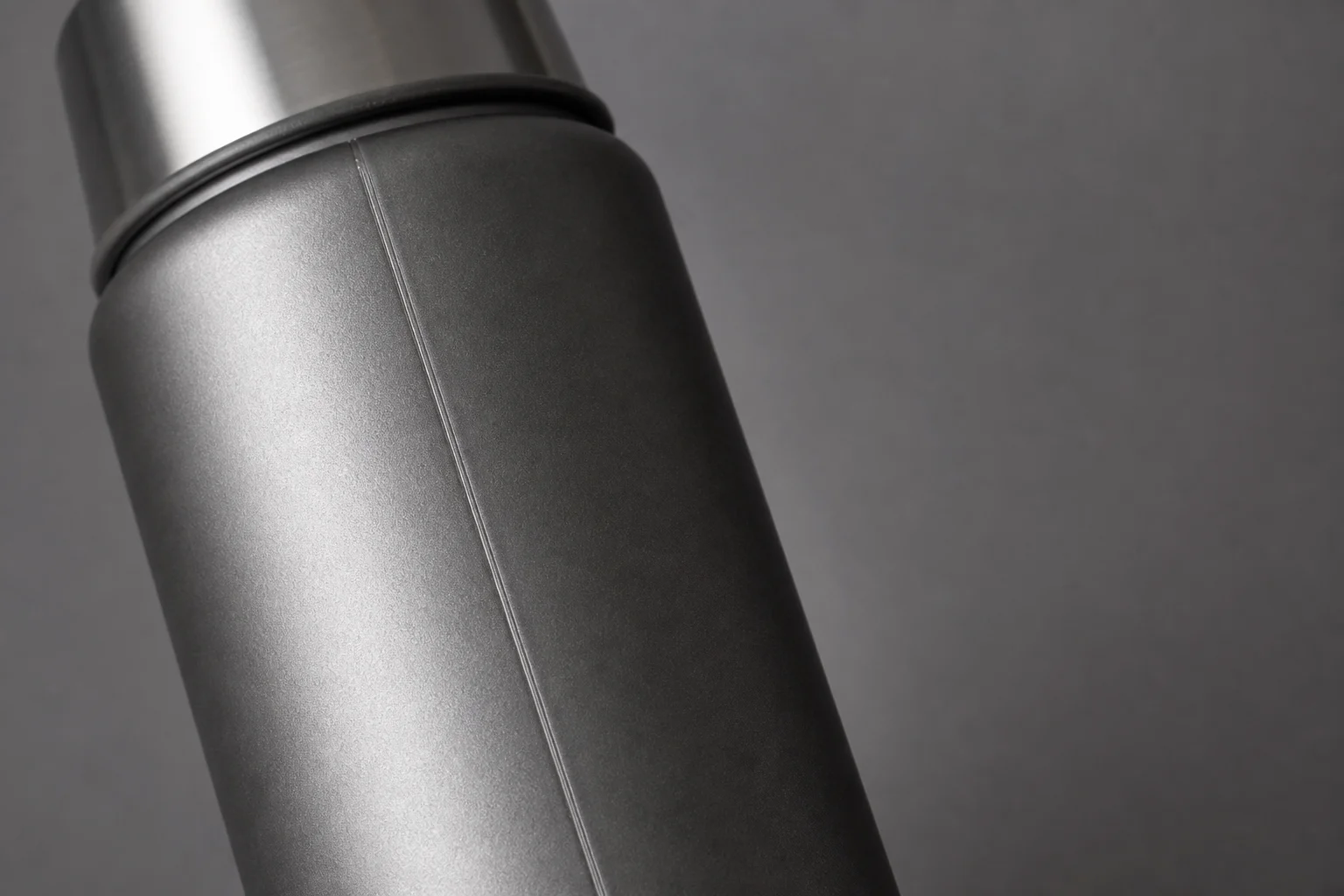 Stainless steel thermos with visible seam detail and matte finish