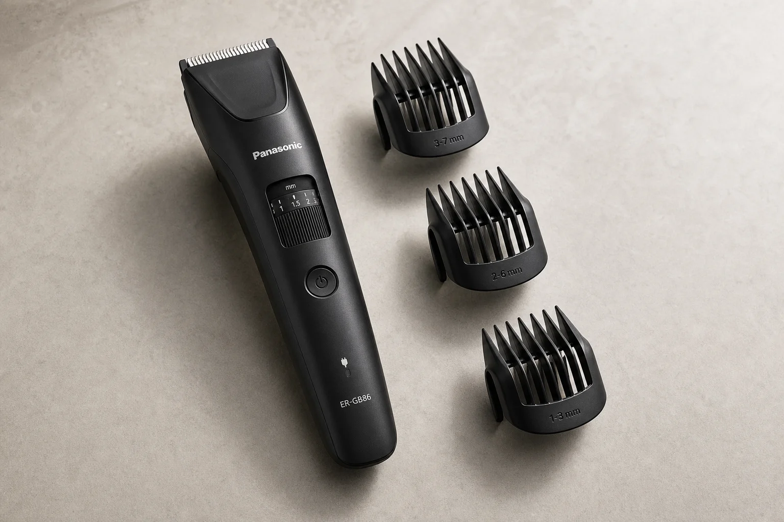 Five professional beard and hair trimmers arranged on concrete surface