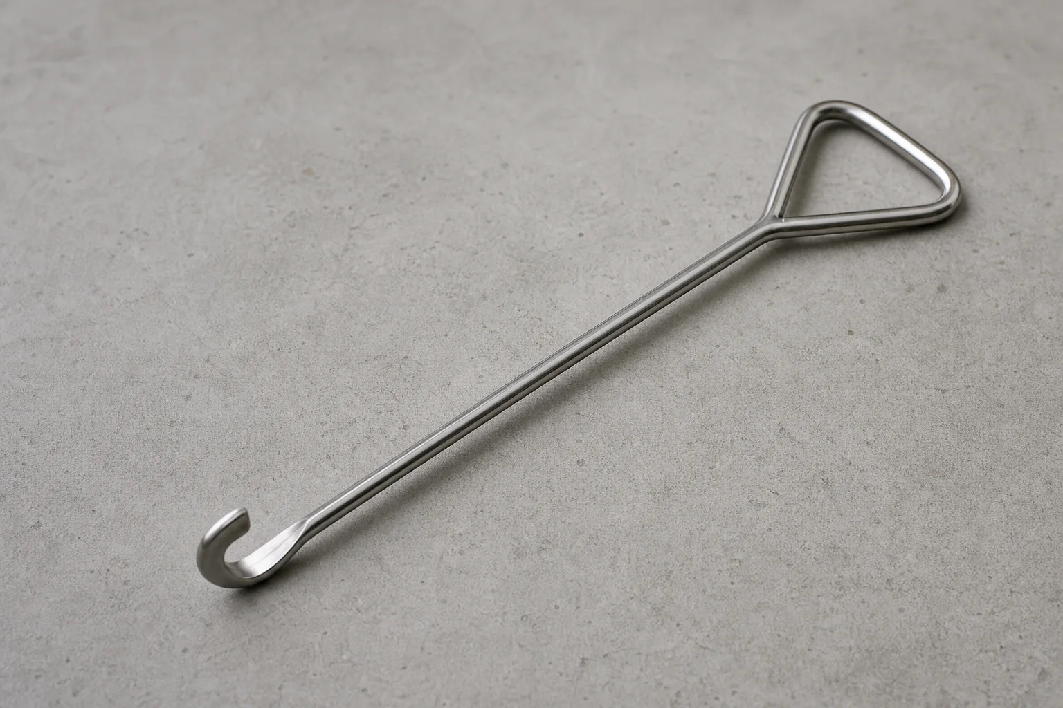 Five kitchen gadgets arranged on concrete surface