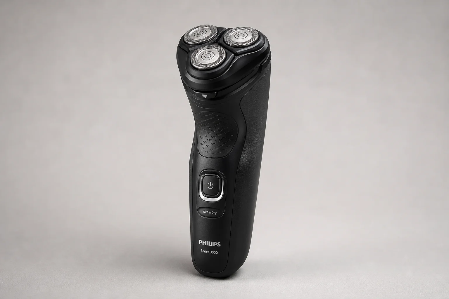 Four Philips shavers from Series 3000 to 9000 Prestige arranged in ascending order on concrete