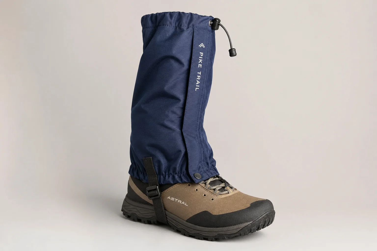 Five leg gaiters in different styles and materials arranged on concrete