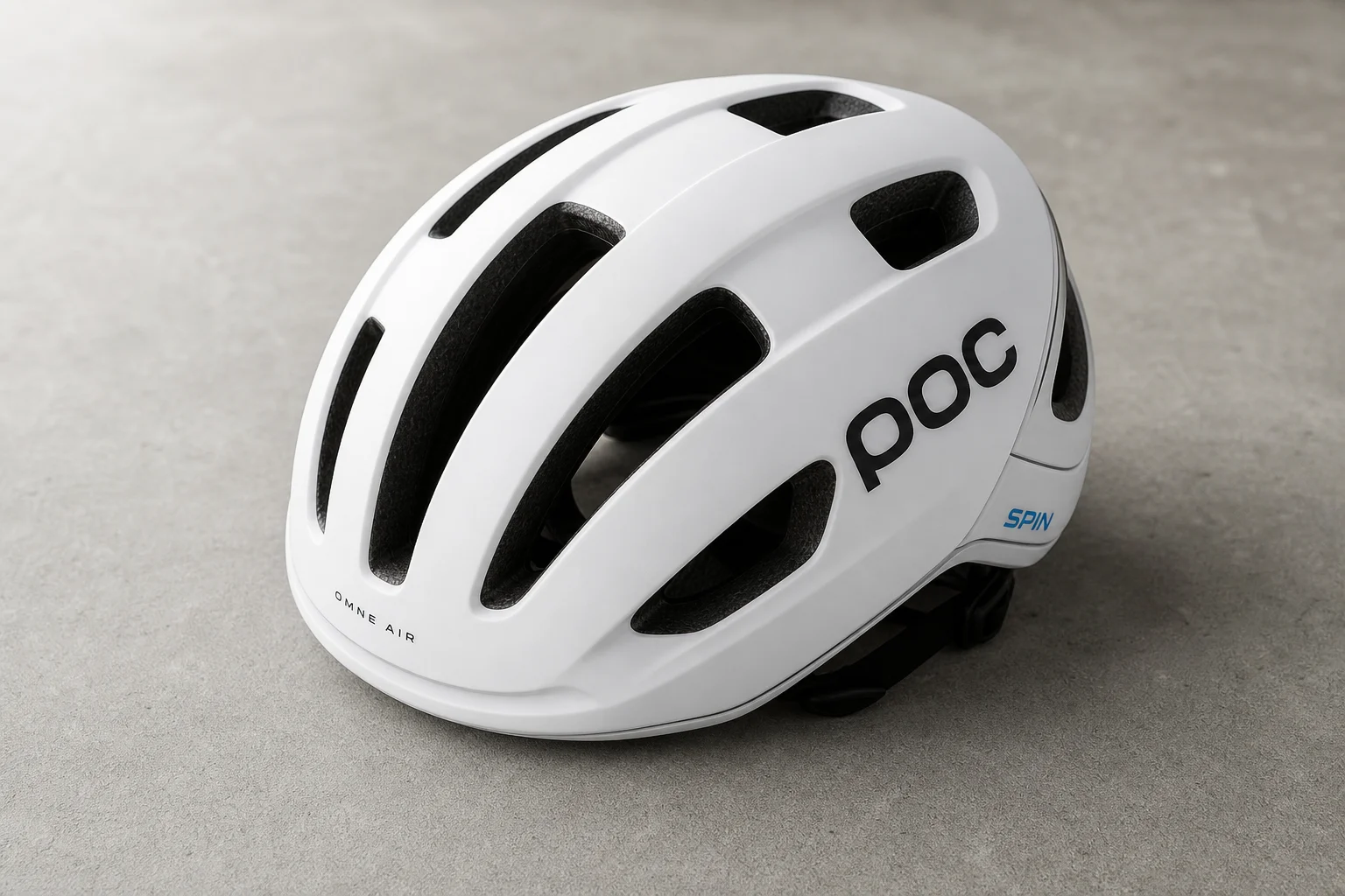 Five road bike helmets arranged in a row on concrete surface showing different designs