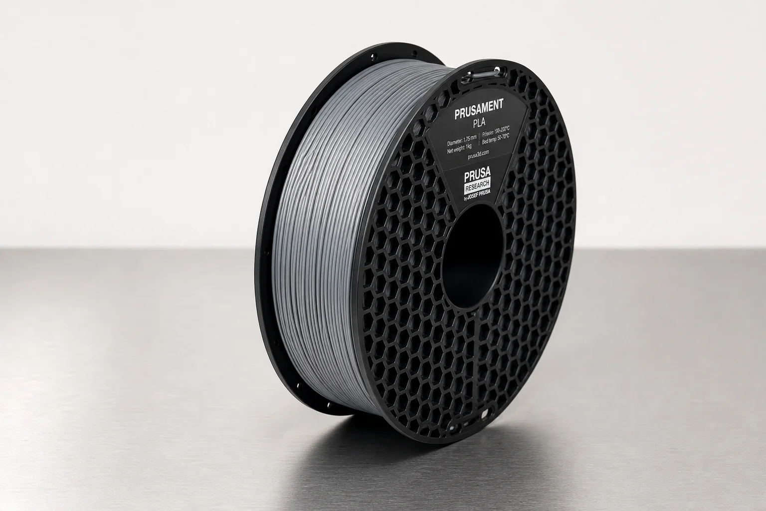 Collection of 3D printer filament spools on concrete surface including PLA, PETG, and specialty materials