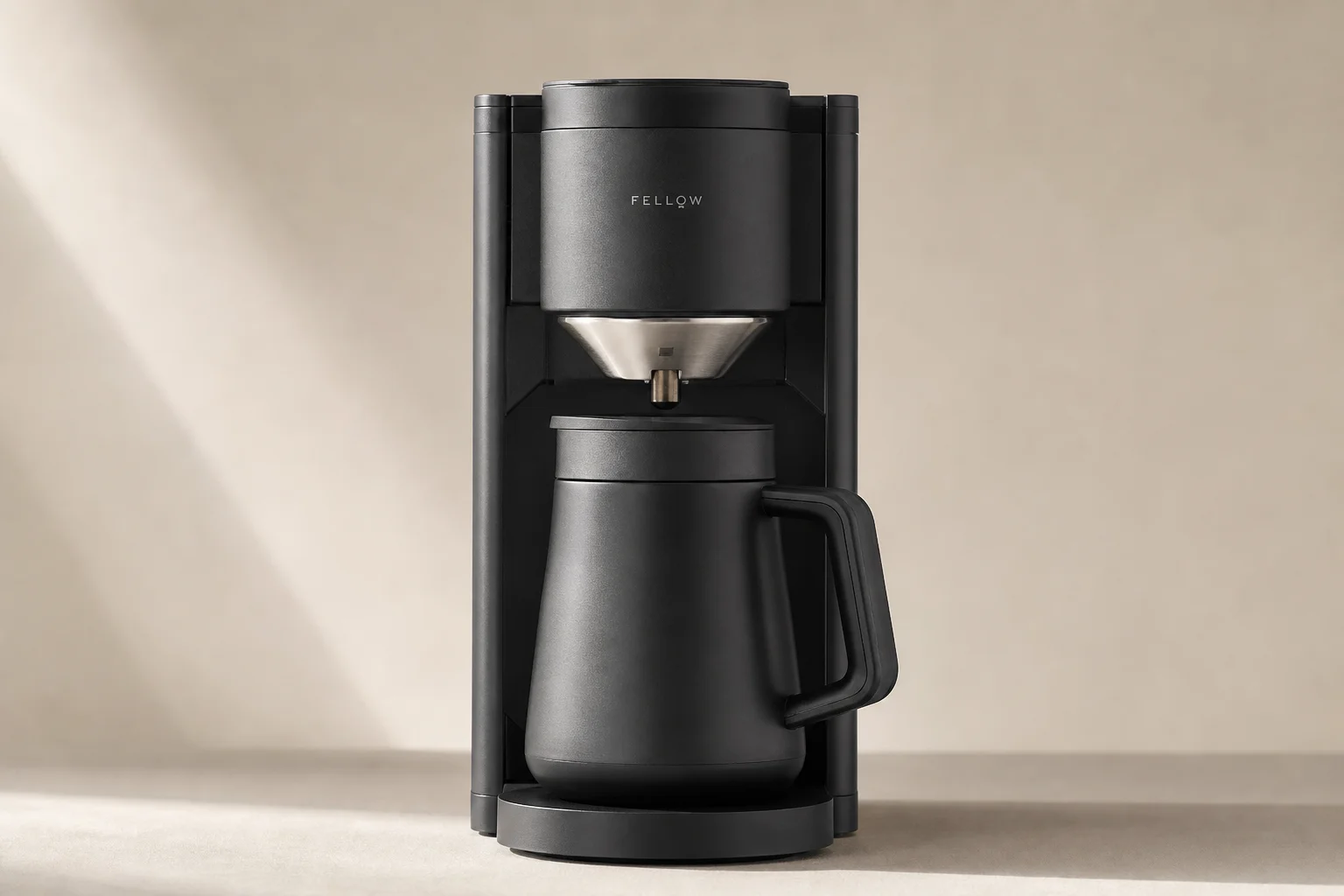 Six automatic coffee makers arranged in a line on concrete surface