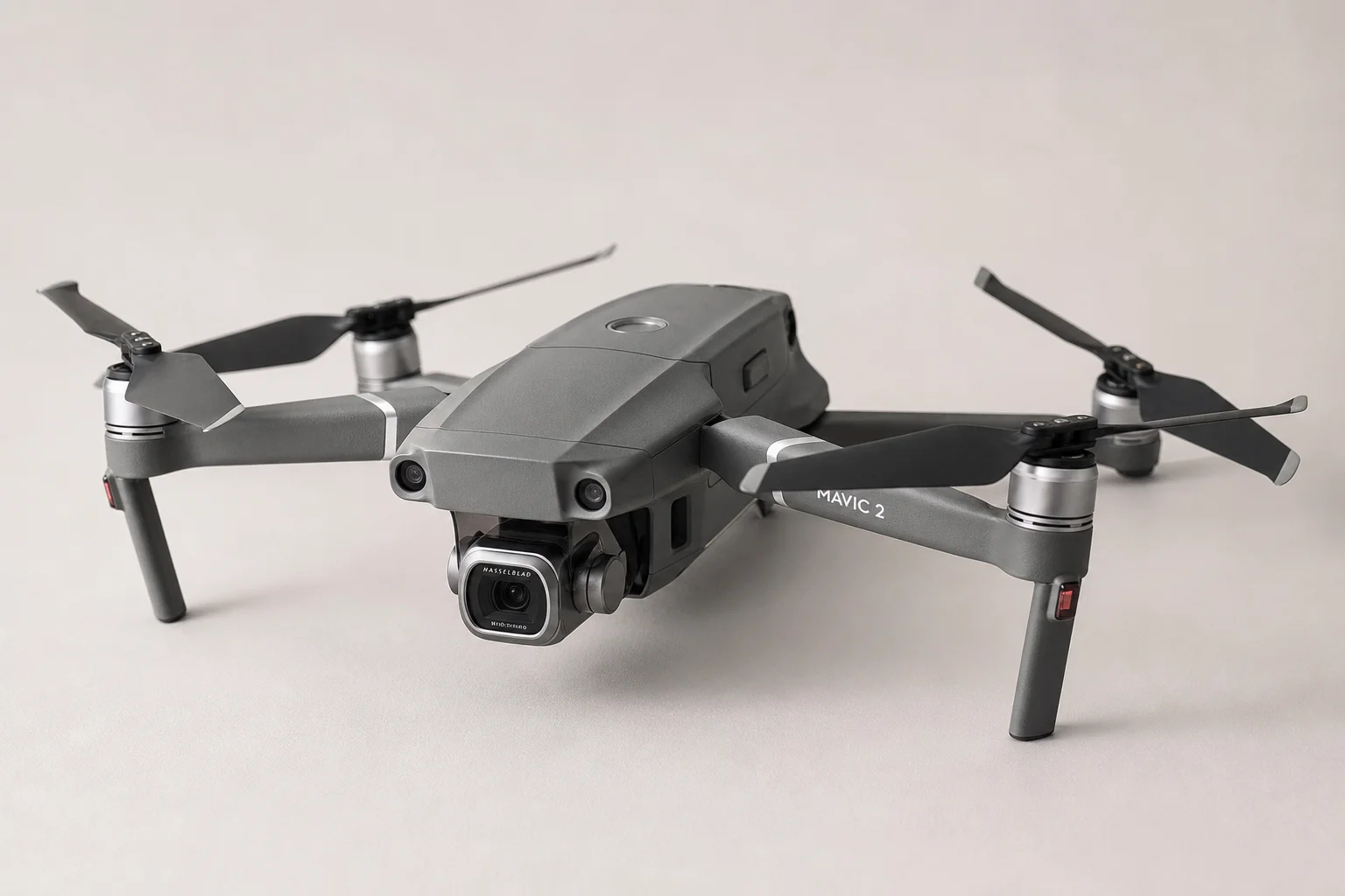 Five budget camera drones in various designs and colors arranged on concrete